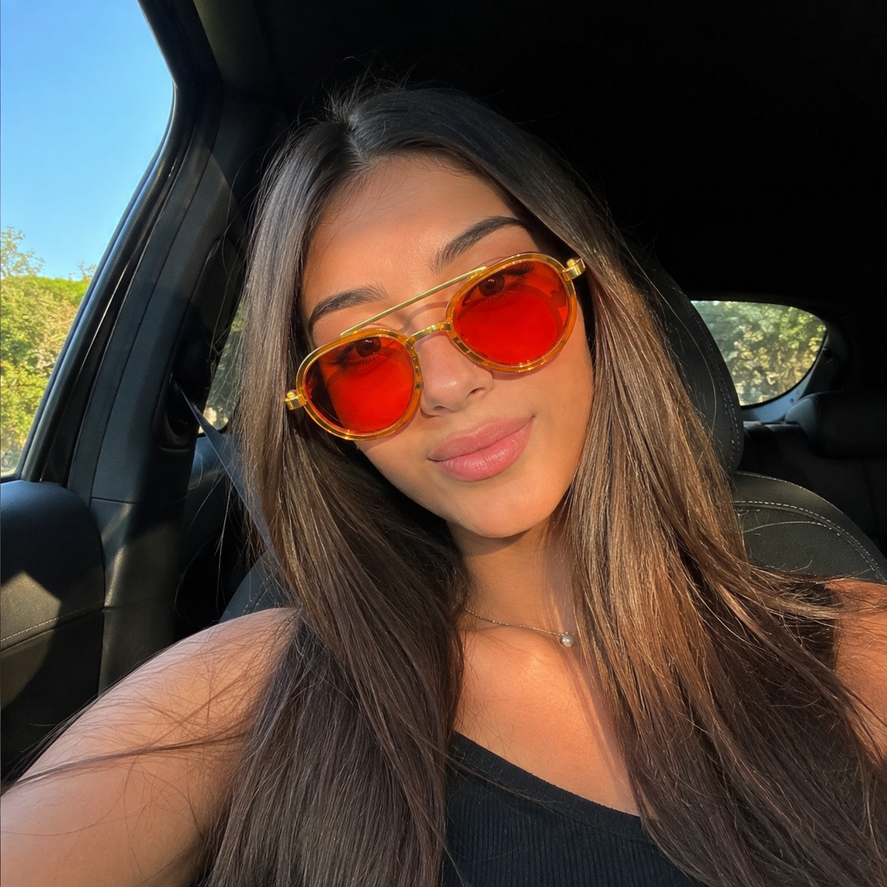 Customer wearing AquaLens Sunset Gold sunglasses in the car